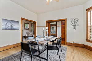 Dining area with ceiling fan and wood-type flooring