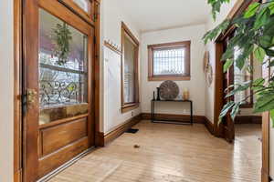 Foyer entrance featuring plenty of natural light and light hardwood / wood-style floors