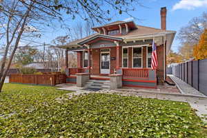 View of front of house featuring a porch and a front lawn