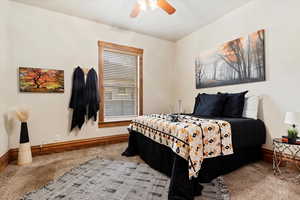 Carpeted bedroom with ceiling fan