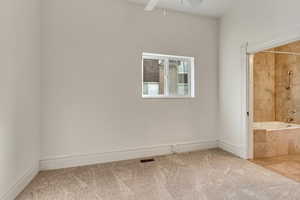 Empty room with carpet and ceiling fan