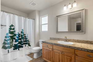 Bathroom with tile patterned floors, vanity, and toilet