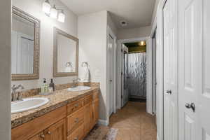 Bathroom featuring tile patterned flooring and vanity