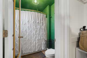 Bathroom with a textured ceiling and toilet