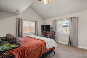 Bedroom with light carpet, vaulted ceiling, and ceiling fan