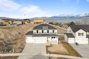 View of front of house with a garage and a water and mountain view