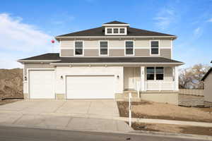 View of property featuring a porch and a garage