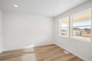 Spare room with light hardwood / wood-style floors