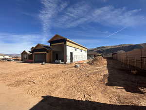 View of side of home featuring a mountain view and a garage