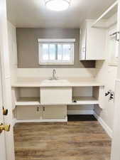 Interior space with hardwood / wood-style floors and sink