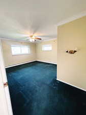 Unfurnished room with baseboard heating, ceiling fan, carpet, and ornamental molding