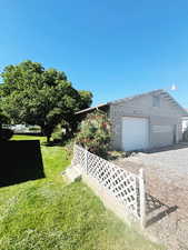 Exterior space featuring a yard and a garage