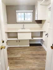 Bathroom with hardwood / wood-style floors and sink