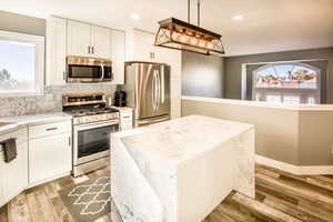 Kitchen view 5   Pretty dining room viewing from back door and LR arched window. Stainless gas range and microwave.