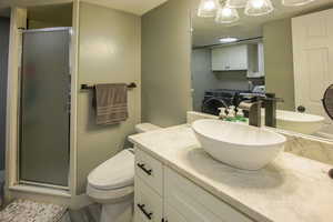 Bathroom featuring LVP floors 3/4 bath  and laundry room combo