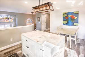 Kitchen view 4. Lovely view from vaulted living room windows featuring light stone counters, view toward hallway