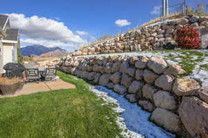 View of yard with a mountain view and a patio area and terraced yard