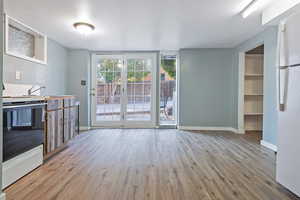 Unfurnished living room featuring light wood-type flooring