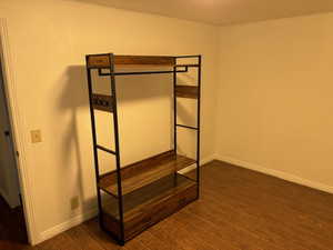 Unfurnished bedroom featuring dark hardwood / wood-style flooring