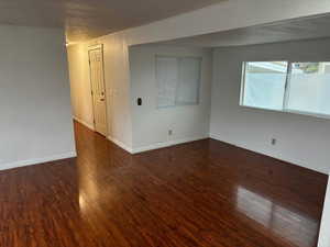 Spare room featuring dark hardwood / wood-style floors