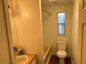 Bathroom with wood-type flooring, vanity, and toilet