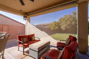 View of patio / terrace featuring ceiling fan and screen