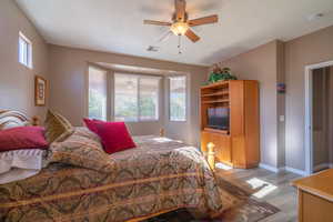 Bedroom with ceiling fan and light hardwood / wood-style floors