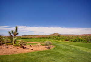 Golf Course featuring a mountain view and a yard