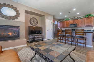 Interior space featuring a tile fireplace, hardwood / wood-style floors, and a textured ceiling