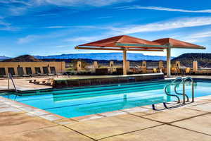 View of pool with a mountain view and a patio area