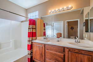 Bathroom featuring vanity and shower / tub combo