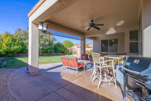 View of patio featuring area for grilling and ceiling fan