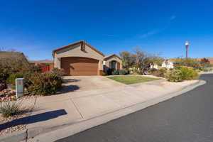 View of front of home featuring a garage and a front yard