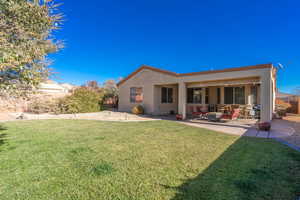 Rear view of house featuring a yard and a patio