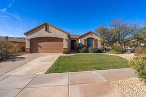 Front of house with a garage and a front lawn