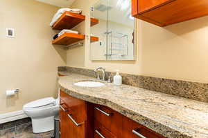 Bathroom featuring tile patterned flooring, vanity, and toilet