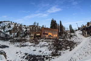 Snow covered house with a mountain view