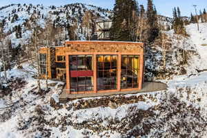 Snow covered house featuring a mountain view