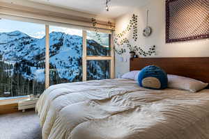 Carpeted bedroom with a mountain view