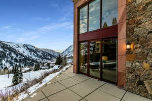 Snow covered patio with a mountain view