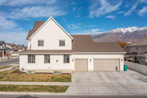 View of front property with a mountain view, a garage, and a front yard