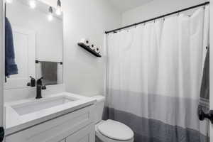 Basement Bathroom with vanity and toilet