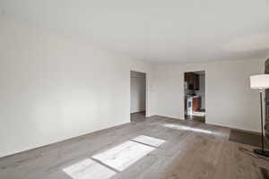 Unfurnished living room featuring light wood-type flooring