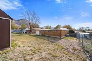 View of yard with a mountain view and a storage unit