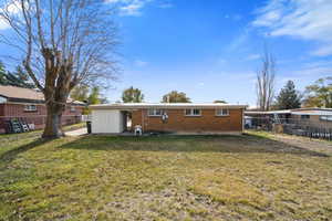 Back of property featuring a lawn