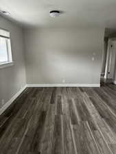 Spare room with dark hardwood / wood-style flooring