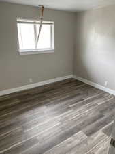 Spare room with dark wood-type flooring