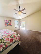 Bedroom with a textured ceiling, carpet floors, and ceiling fan