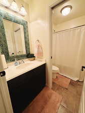 Bathroom with vanity, toilet, and a textured ceiling