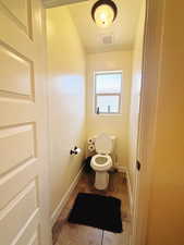 Bathroom featuring tile patterned flooring and toilet